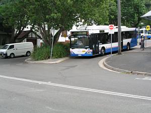 Bus turning left on old Paddington Tram Route